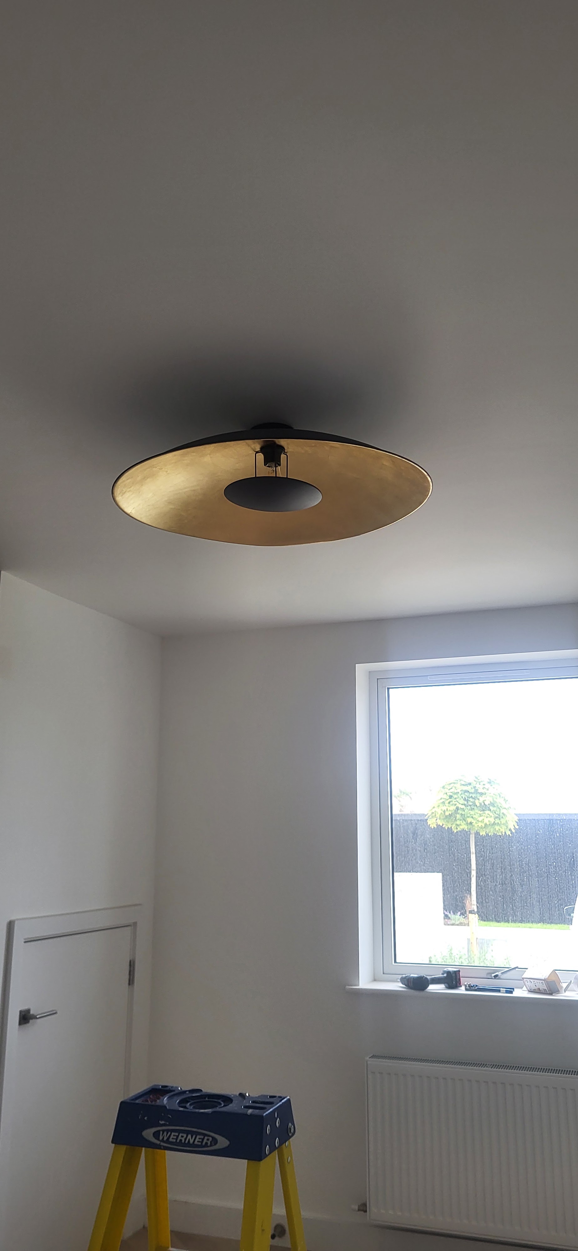 Ceiling light fitted in a freshly painted room